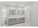 Modern bathroom featuring double sinks, elegant mirrors, and a luxurious soaking tub at 10025 Scottish Pines Ct, Orlando, FL 32832
