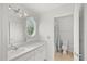 Bright bathroom featuring an oval window and a separate shower at 10025 Scottish Pines Ct, Orlando, FL 32832