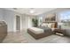 Comfortable bedroom featuring a large bed, hardwood floors, and two windows with lots of natural light at 10025 Scottish Pines Ct, Orlando, FL 32832
