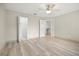 Neutral bedroom with hardwood floors, ceiling fan, and walk-in closet at 10025 Scottish Pines Ct, Orlando, FL 32832