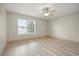 Spacious bedroom with wood-look floors and a ceiling fan at 10025 Scottish Pines Ct, Orlando, FL 32832