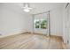 Bedroom featuring wood-look floors, a ceiling fan, and a window with natural light at 10025 Scottish Pines Ct, Orlando, FL 32832