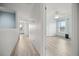Hallway leading to a bedroom with a ceiling fan and natural light at 10025 Scottish Pines Ct, Orlando, FL 32832