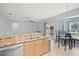 Eat-in kitchen with granite counters, stainless steel appliances, and view to backyard at 10025 Scottish Pines Ct, Orlando, FL 32832