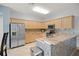 Spacious kitchen with granite countertops and stainless steel appliances at 10025 Scottish Pines Ct, Orlando, FL 32832