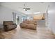 Open-concept living room with breakfast bar, kitchen, and view to the backyard at 10025 Scottish Pines Ct, Orlando, FL 32832