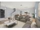 Open-concept living room and dining area with neutral decor and modern furnishings at 10025 Scottish Pines Ct, Orlando, FL 32832