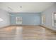 Spacious living room with light wood floors and light blue walls at 10025 Scottish Pines Ct, Orlando, FL 32832