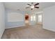 Bright living room with neutral carpet and view into kitchen at 10313 Lake District Ln # S, Orlando, FL 32832