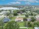 Aerial view of house on a residential street near a lake at 1099 W Embassy Dr, Deltona, FL 32725