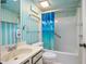 Clean bathroom with shower/tub combo, and retro wallpaper at 117 N Garfield Ave # 1, Deland, FL 32724