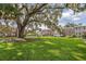 Community lawn with large oak tree and townhouses at 117 N Garfield Ave # 1, Deland, FL 32724