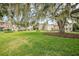 Community green space with large oak tree and homes at 117 N Garfield Ave # 1, Deland, FL 32724