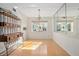 Sunlit dining area featuring hardwood floors, a stained-glass window, and a wooden buffet at 117 N Garfield Ave # 1, Deland, FL 32724