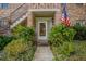 Front door entrance with landscaping and American flag at 117 N Garfield Ave # 1, Deland, FL 32724