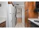 Galley kitchen with refrigerator, washer, dryer, and wood cabinets at 117 N Garfield Ave # 1, Deland, FL 32724