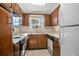 Cozy kitchen featuring wood cabinets, built-in microwave, and stove at 117 N Garfield Ave # 1, Deland, FL 32724