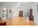 Living room with hardwood floors, access to patio, and view of kitchen at 117 N Garfield Ave # 1, Deland, FL 32724
