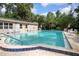 Community swimming pool with lounge chairs at 117 N Garfield Ave # 1, Deland, FL 32724