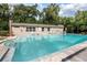 Community pool with lounge chairs and surrounding trees at 117 N Garfield Ave # 1, Deland, FL 32724