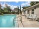 Relaxing community pool with lounge chairs and trees at 117 N Garfield Ave # 1, Deland, FL 32724