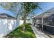Backyard with lush lawn, mature trees, and a privacy fence at 12 Peruvian Ln, Ormond Beach, FL 32174