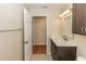 Bathroom with modern vanity, stylish fixtures, and view into another room with wood flooring at 12 Peruvian Ln, Ormond Beach, FL 32174