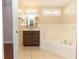 Bathroom with soaking tub, vanity, and tile floors at 12 Peruvian Ln, Ormond Beach, FL 32174