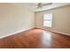 Bright bedroom features sleek wood floors, a ceiling fan, and natural light from the window at 12 Peruvian Ln, Ormond Beach, FL 32174