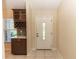 Bright entryway with built-in bar and white door at 12 Peruvian Ln, Ormond Beach, FL 32174