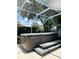 Covered hot tub with steps, set in a screened enclosure and surrounded by lush greenery at 12 Peruvian Ln, Ormond Beach, FL 32174