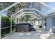 Enclosed back patio features a large hot tub under a screened enclosure at 12 Peruvian Ln, Ormond Beach, FL 32174