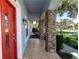 Covered porch with stone columns and tile flooring at 12 Peruvian Ln, Ormond Beach, FL 32174