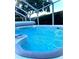 Inviting swim spa with blue water under a screened enclosure at 12 Peruvian Ln, Ormond Beach, FL 32174