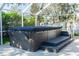 Relax in this covered swim spa with steps and a dark cover at 12 Peruvian Ln, Ormond Beach, FL 32174