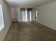 Spacious living room with neutral carpeting and sliding glass doors at 1209 August Sky Dr, Deltona, FL 32738