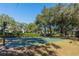 Outdoor basketball court surrounded by lush trees and landscaping at 1278 Chessington Cir, Lake Mary, FL 32746