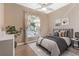 Bedroom with natural light streaming in through large windows, complemented by stylish decor and a soothing ambiance at 1278 Chessington Cir, Lake Mary, FL 32746