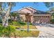 Charming single-story home with manicured lawn, an orange front door, and attached two-car garage at 1278 Chessington Cir, Lake Mary, FL 32746