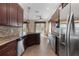 Gourmet kitchen with granite countertops, dark wood cabinetry, and stainless steel appliances at 1278 Chessington Cir, Lake Mary, FL 32746