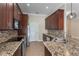 A kitchen with stainless steel appliances, granite countertops, and mosaic backsplash, providing a modern and stylish cooking space at 1278 Chessington Cir, Lake Mary, FL 32746