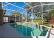 Refreshing pool inside a screened enclosure with sunlit patio area, offering a perfect blend of indoor-outdoor living at 1278 Chessington Cir, Lake Mary, FL 32746