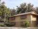 Tan building with brown roof and shutters, showing parking and landscaping at 130 Jasmine Woods Ct # 15C, Deltona, FL 32725