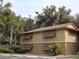 Tan two-story building with brown shutters at 130 Jasmine Woods Ct # 15C, Deltona, FL 32725