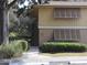 Building exterior with stairs leading to entrance, surrounded by landscaping at 130 Jasmine Woods Ct # 15C, Deltona, FL 32725