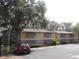 Tan building with brown roof and shutters, with car parked in front at 130 Jasmine Woods Ct # 15C, Deltona, FL 32725