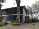 Side view of condo building nestled among trees at 130 Jasmine Woods Ct # 15C, Deltona, FL 32725