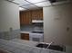 Galley kitchen with wood cabinets, white appliances, and a breakfast bar at 130 Jasmine Woods Ct # 15C, Deltona, FL 32725