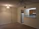 Living room with view into kitchen, carpeted floor, and ceiling fan at 130 Jasmine Woods Ct # 15C, Deltona, FL 32725
