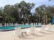 Community pool with lounge chairs and landscaping at 130 Jasmine Woods Ct # 15C, Deltona, FL 32725